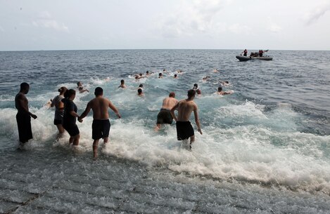 Marines and Sailors with the 31st Marine Expeditionary Unit join the ship's crew in a swim call here, Feb. 27. When operations allow, the ship's captain opens the well deck of the ship for a few hours of swimming in the open water. The 31st MEU is currently deployed aboard three ships of Amphibious Squadron 11, conducting a semi-annual patrol to maintain regional security. The 31st MEU is the Marine Corps' force in readiness for the Asia-Pacific region and the only continuously forward deployed MEU. 