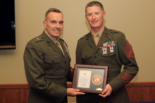 Brig. Gen. Vincent A. Coglianese, left, presented Gunnery Sgt. Andy Darnell Jr., right, with the Armed Services YMCA's 2012 military volunteer of the year award, during the 69th annual Board Installation and Volunteer Recognition Dinner on Jan. 18, for over 100 hours of volunteering with the organization. Coglianese is the base commanding general of Camp Pendleton and regional authority of five Marine Corps bases in the Southwestern United States and Darnell is from 2nd Battalion 5th Marines.