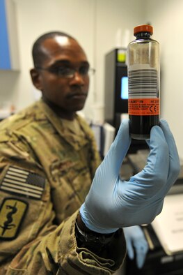 Tech. Sgt. Terrence Raybon, 455th Expeditionary Medical Support Squadron laboratory technician, holds a vial of donated blood at the Craig Joint Theater Hospital on Bagram Airfield, Afghanistan, Jan. 24, 2013. The hospital lab technicians constantly monitor the stocked blood through quality control measures to ensure safety and proper distribution to the hospital patients. (U.S. Air Force photo/Senior Airman Chris Willis)