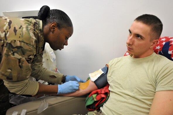 U.S. Army Sgt. Tahera Parker, 432nd Blood Support Detachment laboratory technician, draws blood platelets from Spc. Paul Bizzoco, 582nd Medical Logistics Company, at the Craig Joint Theater Hospital on Bagram Airfield, Afghanistan, Jan. 24, 2013.  The 432nd BSD is responsible for supplying blood products throughout Afghanistan.  (U.S. Air Force photo/Senior Airman Chris Willis)