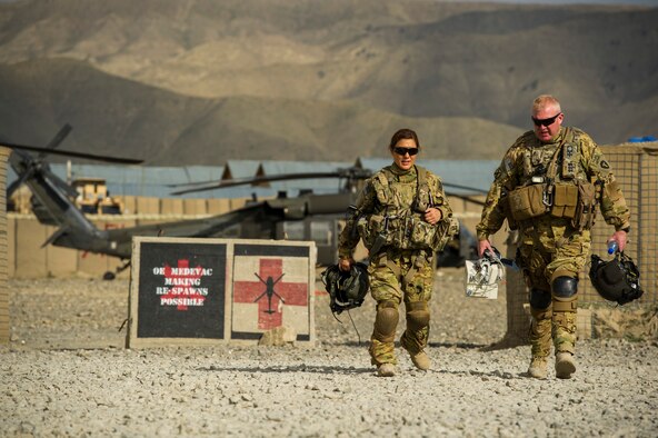 U.S. Air Force Maj. Sandy Nestor, tactical critical care evacuation team nurse, left, 3rd Platoon, C Company, 2-149 General Support Aviation Battalion Medical Evacuation, and U.S. Army Sgt. James Maher, flight medic, right, C Co. 2-149th GSAB MEDEVAC, walk to the Forward Surgical Team building for a patient transfer mission, on Forward Operating Base Orgun East, Paktika, Afghanistan, May 13, 2013 MEDEVAC teams specialize in moving and treating U.S. and coalition forces who are injured and risk dying without immediate emergency care. (U.S. Air Force photo/Staff Sgt. Marleah Miller)