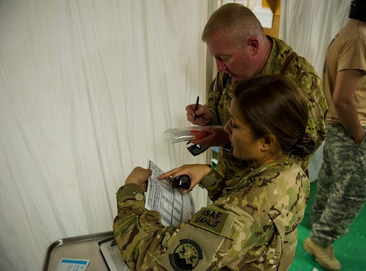 U.S. Air Force Maj. Sandy Nestor, tactical critical care evacuation team nurse, left, 3rd Platoon, C Company, 2-149 General Support Aviation Battalion Medical Evacuation , and U.S. Army Sgt. James Maher, flight medic, right, C Co. 2-149th GSAB MEDEVAC, gather information on a patient before a patient transfer mission,  Forward Operating Base Orgun East, Paktika, Afghanistan, May 13, 2013. MEDEVAC teams specialize in moving and treating U.S. and coalition forces who are injured and risk dying without immediate emergency care. (U.S. Air Force photo/Staff Sgt. Marleah Miller)