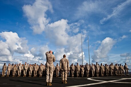 Sergeant Maj. William J. Grither, sergeant major of Combat Logistics Battalion 31, 31st Marine Expeditionary Unit, reads a promotion warrant to a formation of Marines during a promotion ceremony here, July 1. This month, four CLB Marines  aboard USS Germantown were promoted to various ranks from lance corporal to sergeant. The 31st MEU is the only continuously forward-deployed MEU and is the Marine Corps’ force in readiness in the Asia-Pacific region.