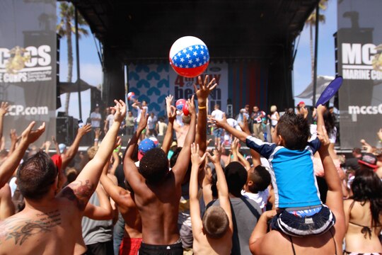 Beach goers jump and reach to volley a beach ball at Del Mar Beach here during the Fourth of July Beach Bash. The daylong event featured live entertainment, free give-aways, a military tribute video and concluded with fireworks.
