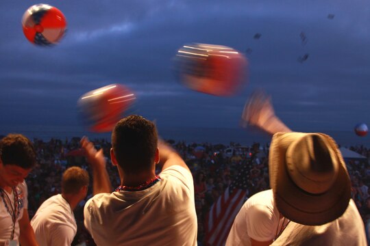 Volunteers throw beach balls and event shirts to the crowd at Del Mar Beach here during the Fourth of July Beach Bash. The daylong event featured live entertainment, free give-aways, a military tribute video and concluded with fireworks.

