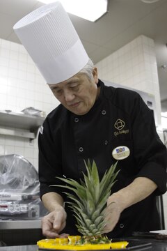 Senji Shoya, Club Iwakuni supervisor, prepares a fruit display for an upcoming party at Club Iwakuni at Marine Corps Air Station Iwakuni, Japan, June 27, 2013. Shoya is in charge of planning large events, including the Marine Corps Birthday Ball.