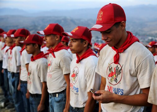 A Devil Pups stands and admires his challenge coin in a formation on top of the Alpha shelf in the 52-area after climbing Old Smokey, earning their title “Devil Pup” here July 11. In order to graduate the program, each teen must pass several tests, such as climbing to the top of Old Smokey. Devil Pups Inc. encampments are a ten-day youth camp that teaches discipline and respect to teenagers age 14-17.

