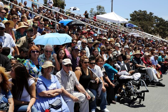 Family members watch as their teenagers march onto the 52-area parade deck on the day of their graduation from the Devil Pups Incorporated program held here July 13. Devil Pups Inc. encampments are a ten-day youth camp that teaches discipline and respect to teenagers age 14-17.