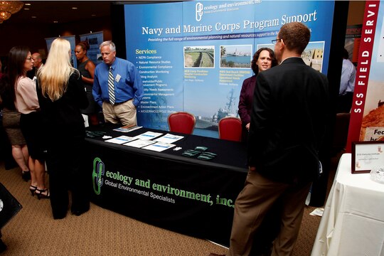 David McIntyre and Sandra Pentney speak with sponsors at their exhibit during the “Camp Pendleton Day” event held at the Pacific Views event center here July 18.  Both McIntyre and Pentney are global environmental specialists for Ecology and Environment Incorporated. The Society of American Military Engineers holds the annual “Camp Pendleton Day” event every year in support of the war fighter, specifically the engineering industry.