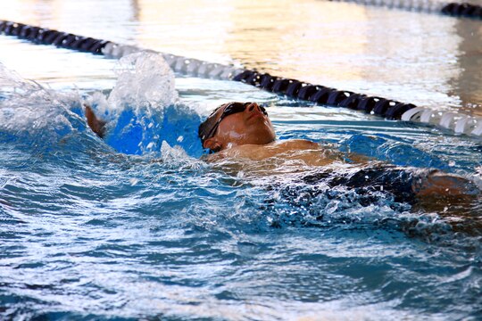 Sgt. Dominic Thiemann, a patient from Wounded Warrior Battalion West, practices the one-arm backstroke during a wounded warrior swim camp here July 18. 
