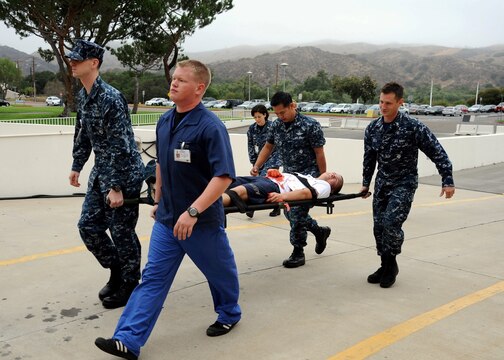 Naval Hospital Camp Pendleton litter bearers transport a simulated mass casualty patient to the hospital’s Emergency Room during an active shooter exercise July 18.  The scenario was based on an active shooter incident at the hospital’s Mental Health Clinic (simulated in building H-103) and how responders dealt with the threat, mass casualty patient transportation and accountability, Emergency Room triage and treatment and the Hospital Command Center’s coordination efforts and oversight.

U.S. Navy photo by Mass Communication Specialist 1st Class Michael R. McCormick
