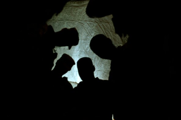 Chaplain (Capt.) Myung Cho and his assistant pray with Airmen assigned to the 455th Expeditionary Security Forces Group prior to them going on shift at Bagram Air Field, Afghanistan, July 21. He visits the airmen as much as he can to raise their morale and offer a variety of worship services. ( U.S. Air Force photo/ Staff Sgt. Stephenie Wade) 

