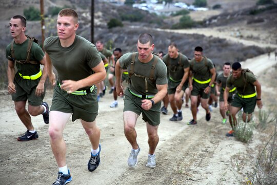 Marines in the Lance Corporal Seminar run to the top of a hill during a morning physical fitness seminar held at Marine Corps Air Station here July 25. The Lance Corporal Seminar is a three-day course that the air station started this year to provide junior Marines with the knowledge and skills to progress in their military careers.