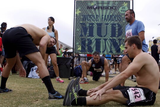 Competitors stretch before the 20th Annual World Famous Mud Run here June 1.  Several obstacles were incorporated into the 10K race, which started at Lake O’Neil, and took the runners through training areas 26 and 27 of the base.  