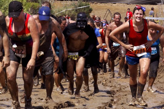 Competitors trudge up “Slippery Hill” during the 20th annual World Famous Mud Run here June 1.  Several obstacles were incorporated into the 10K, which started at Lake O’Neil, and took the runners through training areas 26 and 27.  