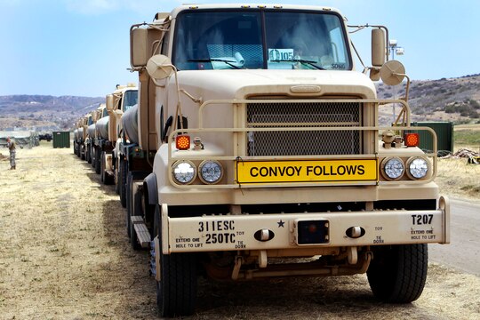 A convoy of Army Reserve M-915A5 Line-Haul Tractors prepare to depart from the sierra-training site here during the Quartermaster Liquid Logistics exercise held in the 62-area here June 6. The Quartermaster Liquid Logistics Exercise is an Army reserve exercise that helps train service members in the movement of large amount of fuels from one fuel farm to another.