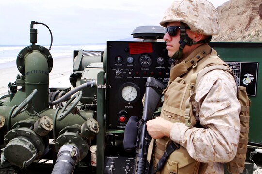 Lance Cpl. Andrew Kissinger monitors a pipeline that comes onto shore and the first pump for the Gold Beach fuel farm during the Quartermaster Liquid Logistics exercise held here June 6. The Quartermaster Liquid Logistics Exercise is an Army reserve exercise that helps train service members in the movement of large amount of fuels from one fuel farm to another. Kissinger is a bulk fuel specialist and a pump operator for Bulk Fuel Company A, stationed in Tucson, Ariz.