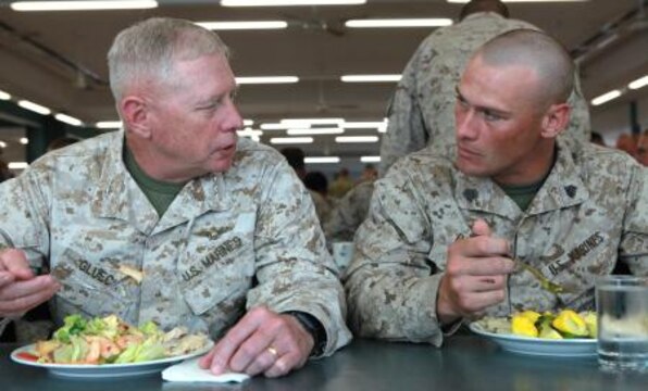 Lt. Gen. Kenneth Glueck, Jr., commanding general, III Marine Expeditionary Force, speaks with Sgt. Donald Bowley, assault section leader, Weapons Platoon, Lima Company, 3rd Battalion, 3rd Marine Regiment, Marine Rotational Force – Darwin, during lunch at the Northern Other Rank’s Mess, here, May 28. Glueck flew to Australia to visit MRF-D Marines and tour surrounding military facilities.
