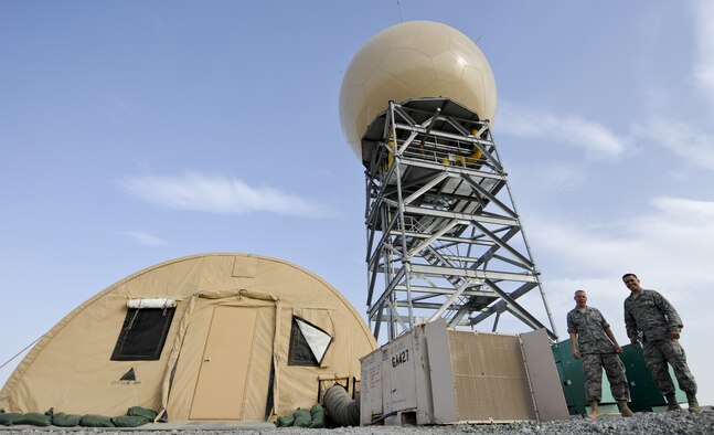 U.S. Air Force Staff Sgt. Kermit Perez, right, and U.S. Air Force Tech. Sgt. Scott Aysenne, radar maintenance technicians with the 727th Expeditionary Air Control Squadron pose for a photo in front of an AN/TPS 75 radar site that was just completed at an undisclosed location in Southwest Asia June 6, 2013. The 727th EACS consists of the 255th Air Control Squadron from Gulfport, Miss., with augmentation from eight Air National Guard units and an Air Defense Artillery Fire Control Officer/Assistant team from 69th Air Defense Artillery Brigade, Fort Hood, Texas.  The 255th ACS has deployed four times in support of contingency operations overseas in the past ten years. (U.S. Air Force photo by Senior Airman Jacob Morgan)