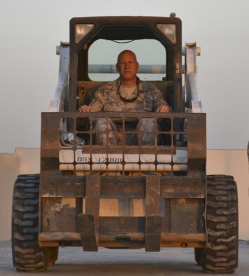 U.S. Air Force Master Sgt. Tracey Scruggs, a radar maintenance technician from the 727th Expeditionary Air Control Squadron drives a forklift supporting the project of moving an AN/TPS 75 radar to a lifted position at an undisclosed location in Southwest Asia May 29, 2013. The goal of the project was to protect the AN/TPS 75 radar from the harsh wind and heat of the region. The 727th EACS consists of the 255th Air Control Squadron from Gulfport, Miss., with augmentation from eight Air National Guard units and an Air Defense Artillery Fire Control Officer/Assistant team from 69th Air Defense Artillery Brigade, Fort Hood, Texas.  The 255th ACS has deployed four times in support of contingency operations overseas in the past ten years. (U.S. Air Force photo by Master Sgt. Seaton Hixson)