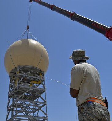 U.S. Air Force Master Sgt. Eddie Sumrell, from the 727th Expeditionary Air Control Squadron, helps guide the protective radome over an AN/TPS 75 radar at an undisclosed location in Southwest Asia May 29, 2013. The goal of the project was to protect the AN/TPS 75 radar from the harsh wind and heat of the region. The 727th EACS consists of the 255th Air Control Squadron from Gulfport, Miss., with augmentation from eight Air National Guard units and an Air Defense Artillery Fire Control Officer/Assistant team from 69th Air Defense Artillery Brigade, Fort Hood, Texas.  The 255th ACS has deployed four times in support of contingency operations overseas in the past ten years. (U.S. Air Force photo by Master Sgt. Seaton Hixson)