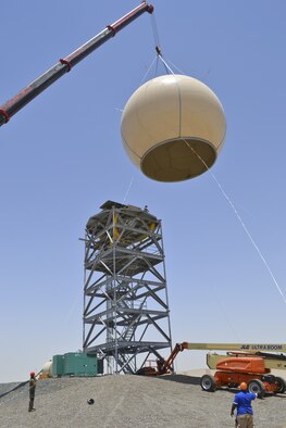 Members of the 727th Expeditionary Air Control Squadron and contractors lift a protective radome with a crane to place it over an AN/TPS 75 radar at an undisclosed location in Southwest Asia May 29, 2013. The goal of the project was to protect the AN/TPS 75 radar from the harsh wind and heat of the region. The 727th EACS consists of the 255th Air Control Squadron from Gulfport, Miss., with augmentation from eight Air National Guard units and the Air Defense Artillery Fire Control Officer/Assistant team from 69th Air Defense Artillery Brigade, Fort Hood, Texas.  The 255th ACS has deployed four times in support of contingency operations overseas in the past ten years. (U.S. Air Force photo by Master Sgt. Seaton Hixson)