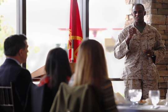 Lt. Col. Sinclair Smith, right, speaks to three high school graduates, who have been nominated to attend a U.S. military academy, during the annual Academy Breakfast at the Pacific Views Event Center here June 15. Smith is a Naval Academy graduate and housing officer here.