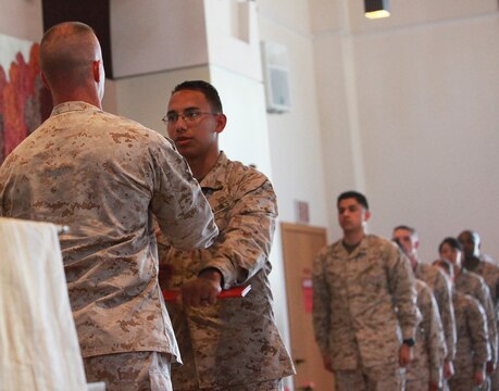 Lieutenant Col. Michael J. Fitzgerald, left, commanding officer, 1st Supply Battalion, Combat Logistics Regiment 15, 1st Marine 
Logistics Group, hands a certificate of appreciation to a Marine with 1st Supply Bn. during a capstone ceremony aboard Camp 
Pendleton, Calif., May 23, 2013. The Marines were recognized for their honorable service to the Marine Corps.
