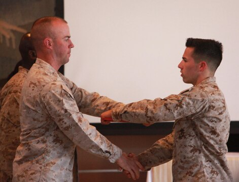 Lieutenant Col. Michael J. Fitzgerald, left, commanding officer, 1st Supply Battalion, Combat Logistics Regiment 15, 1st Marine 
Logistics Group, hands a certificate of appreciation to a Marine with 1st Supply Bn. during a capstone ceremony aboard Camp 
Pendleton, Calif., May 23, 2013. The Marines were recognized for their honorable service to the Marine Corps.
