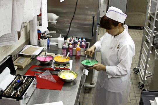Kaori Nohara, Club Iwakuni chef, mixes food coloring into icing as she prepares to decorate a birthday cake for a customer at Club Iwakuni, Marine Corps Air Station Iwakuni, Japan, June 21, 2013. Nohara said she does all of her decorating by hand using only a photo for reference.