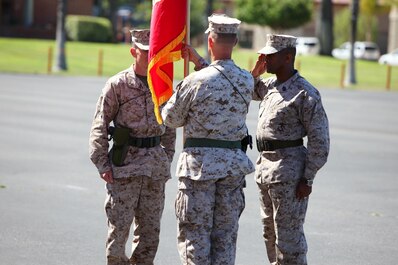 Lieutenant Col. Christian D. Richardson, center, outgoing commanding officer, 1st Maintenance Battalion, Combat Logistics Regiment 15, 1st Marine Logistics Group, passes on his battalion’s battle colors to the oncoming commanding officer, Lt. Col. Mark T. Donar,. left, during a change of command ceremony aboard Camp Pendleton, Calif., June 27, 2013. Richardson has served as the commanding officer since June 17, 2011.