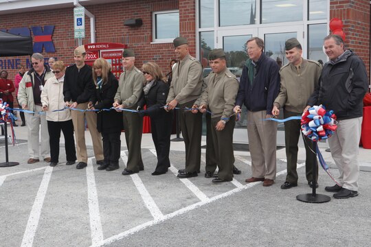 Service members and Marine Corps Community Services representatives cut the ribbon for the grand opening of the new Marine Corps Exchange aboard Stone Bay on Feb. 22. The facility is bigger than the old one and has a larger selection of available items for purchase.