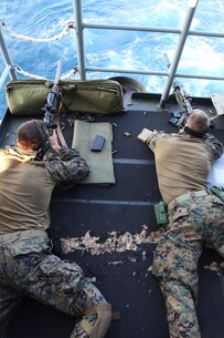 Marines with the Amphibious and Force Reconnaissance Platoons of the Maritime Raid Force, 31st Marine Expeditionary Unit, fire M110 Semi-Automatic Sniper Systems and M40A5 Sniper Rifles at targets from the stern of the ship here, March 6. The snipers of the MRF conducted marksmanship training to keep their skills sharp for any contingency operation they may be called upon to execute. The 31st MEU is the only continuously forward-deployed MEU and is the Marine Corps’ force in readiness in the Asia-Pacific region.