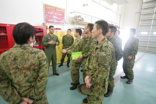 Gunnery Sgt. Nathan K. Lanham, an Aircraft Rescue Firefighting section leader, leads a tour for Japan Ground Self Defense Force soldiers of ARFF facilities here Feb. 28, 2013.