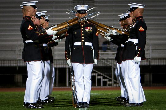 The Marine Corps Silent Drill Platoon performs during Battle Color Detachment ceremony at Veterans Memorial Stadium, Yuma, Ariz., March 2, 2012. The Battle Color Detachment, composed by the Silent Drill Platoon, the U.S. Marine Drum and Bugle Corps and Marine Corps Color Guard, is currently on its national installations tour.