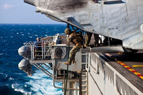 A Marine with the Maritime Raid Force, 31st Marine Expeditionary Unit, fast ropes out of a CH-46E Sea Knight helicopter during helicopter rope suspension techniques training here, March 7. The purpose of the fast rope insertion is to deploy Marines and Sailors in a situation where a helicopter cannot land. The 31st MEU maintains the fast rope capability for use in numerous contingencies from combat insertions to humanitarian operations.   The 31st MEU is the only continuously forward-deployed MEU and is the Marine Corps’ force in readiness in the Asia-Pacific region.