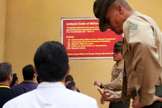 Sgt. Mark Reconsal, foreground, and Staff Sgt. John Delgado, give the Marine Corps Executive Forum participants an exposition on the receiving period of recruit training at Marine Corps Recruit Depot San Diego March 7. Reconsal and Delgado are both drill instructors with Support Battalion, Receiving Company.