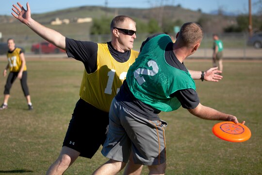 Capt. Jerome Lowe, left, an infantry officer at Wounded Warrior Battalion West attempts to block a pass from his opponent during an ultimate Frisbee tournament at the Camp Horno Football Field here March 13.
