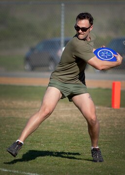 Petty Officer 2nd Class Rob Webb, a Special Amphibious Reconnaissance Corpsman with 1st Reconnaissance Battalion, makes a return pass to the other team after scoring during an ultimate Frisbee tournament at the Camp Horno Football Field here March 13.