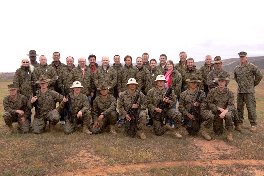 The participants of the West Coast Marine Corps Executive Forum pose with Marines for a group photo at Edson Range Marine Corps Base Camp Pendleton March 7. The Marines are field instructors with Weapons Field Training Battalion, Marine Corps Recruit Depot San Diego. 