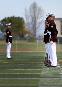 The Silent Drill Platoon stands in formation awaiting a rifle inspection, while more than 1,000 spectators sat in attedance at the 2013 Battle Color Ceremony at the Paige Fieldhouse Football Field here March 15.