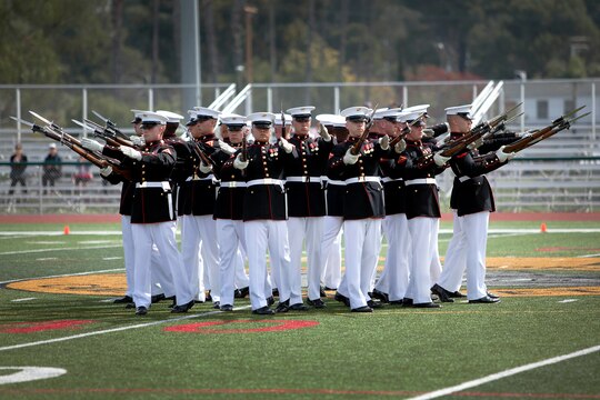 The Silent Drill Platoon performs a maneuver called the “bursting bomb” during the Battle Color Ceremony at the Paige Fieldhouse Football Field here March 15.