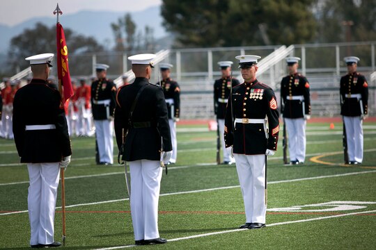Staff Sgt. Scott Wilkie, the Silent Drill Platoon Sergeant, awaits review by the platoon commander during the Battle Color Ceremony at the Paige Fieldhouse Football Field here March 15.
