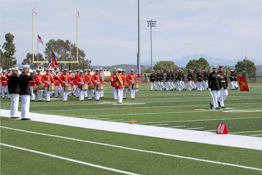 The Battle Color Detachment from Marine Barracks Washington march past, reviewing officers Brig. Gen. Vincent A. Coglianese and Lt. Gen. John A. Toolan, during the Battle Color Ceremony at the Paige Fieldhouse Football Field here March 15. Coglianese is the base commanding general and regional authority of five Marine Corps installations in the southwestern United States and Toolan is the commanding general for the 1st Marine Expeditionary Force here.