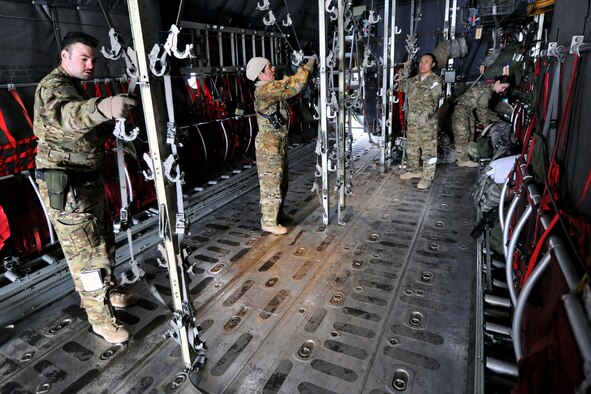 Members of the 455th Expeditionary Aeromedical Evacuation Squadron finish configuring a C-130 Hercules on Bagram Airfield, Afghanistan, Feb. 21, 2013. The 455th EAES provides medical and nursing care in flight to ill or injured servicemembers or Department of Defense civilians.  (U.S. Air Force photo/Senior Airman Chris Willis)