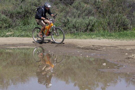 David McNiff avoids a puddle during the last stretch of a 23-mile course on the first Hell Fire Fat Tire Bike Race on Camp Pendleton here March 23. 