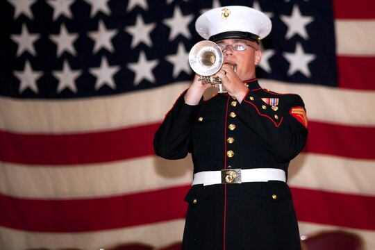 Cpl. Justin Gorham plays taps during the 68th annual Battle of Iwo Jima Commemoration ceremony at the Pacific Views Event Center here March 23. Gorham is a trumpet player for the 1st Marine Division Band.