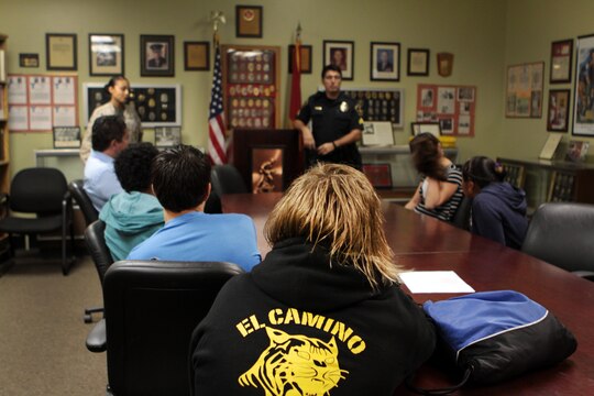 Students from El Camino High School learn about the law enforcement career field from military and civilian police officers at Security Battalion here, Oct. 30. The School-to-Career Program lets students choose a career and learn more about it by shadowing a professional in their working environment.