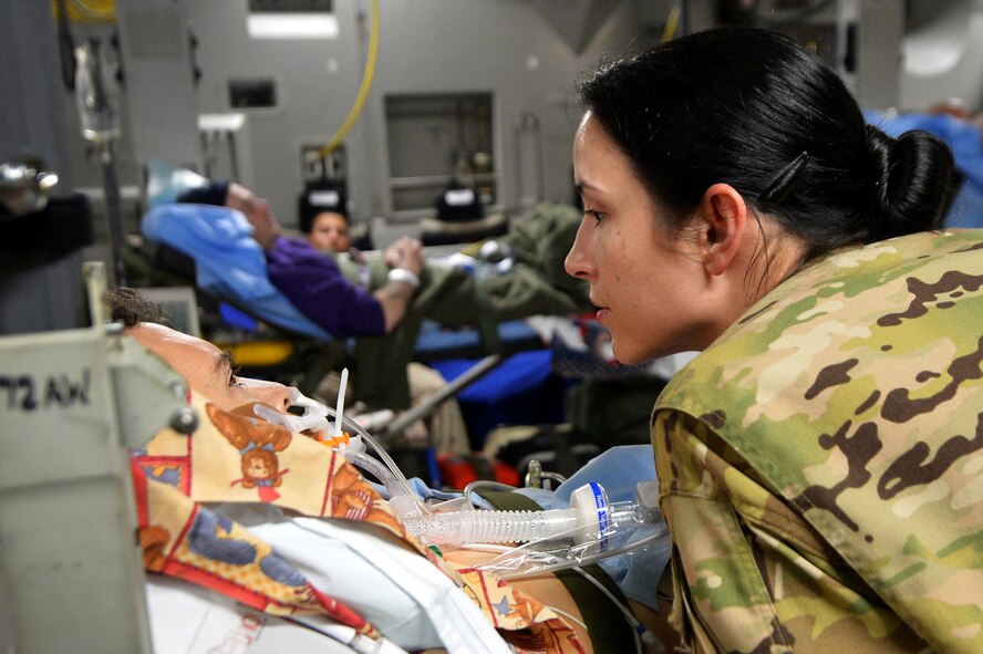Capt. Suzanne Morris, 455th Expeditionary Aeromedical Evacuation Squadron Critical Care Air Transport Team nurse, discusses a care plan with a patient before they depart the aircraft on Ramstein Air Base, Germany, March 21, 2013. The CCATT crew is constantly on their feet during the flight to observe and interact with the patients for any signs of medical need. (U.S. Air Force photo/Senior Airman Chris Willis)