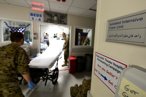 Members of the 455th Expeditionary Aeromedical Evacuation Squadron Critical Care Air Transport Team and the Craig Joint Theater Hospital intensive care unit prepare to transport patients at Bagram Airfield, Afghanistan, March 21, 2013. The CCATT crew will unplug the patient from the hospital’s power and respiratory machines and connect to mobile units that are positioned along with stretchers for transport to a medical aircraft. (U.S. Air Force photo/Senior Airman Chris Willis)